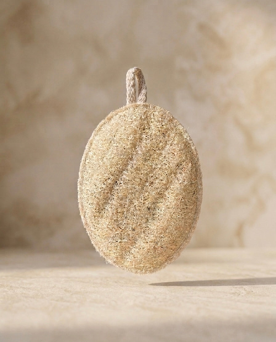 Estropajo natural de luffa ovalado con cuerda de algodón sobre piedra — exfoliante vegetal maro naturals Colombia