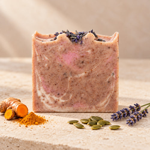 Jabón maroween de maro naturals, barra con vetas rosadas y marrones junto a cúrcuma, lavanda y semillas de calabaza.